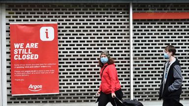 Members of the public walks past a still closed sign outside Argos in Leicester city centre in Leicester, England, Tuesday June 30, 2020. The British government has reimposed lockdown restrictions in the English city of Leicester after a spike in coronavirus infections, including the closure of shops that don...t sell essential goods and schools. (AP Photo/Rui Vieira)